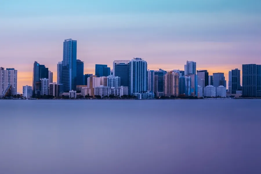 Miami skyline across calm water at dusk