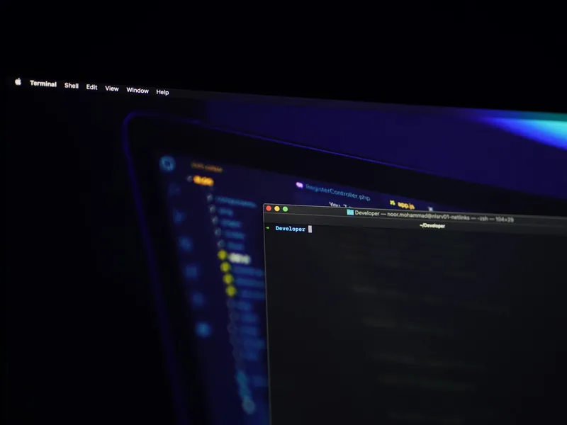 Laptop showing a terminal and code editor