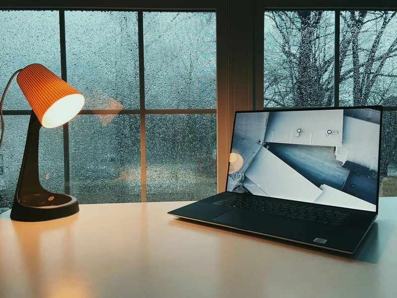 Laptop on a clean desk next to a window