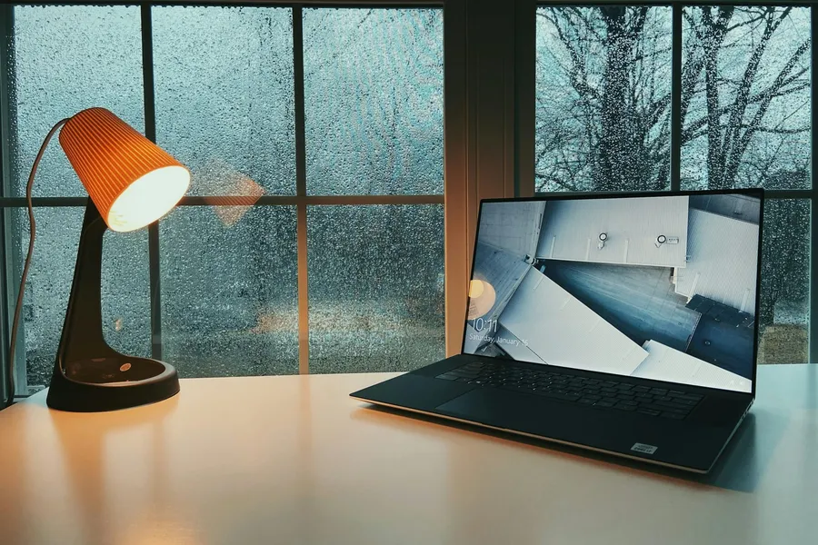 Laptop on a clean desk next to a window